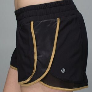 Lululemon Super Squad shorts. Black and gold. Size 6. Built in liner.